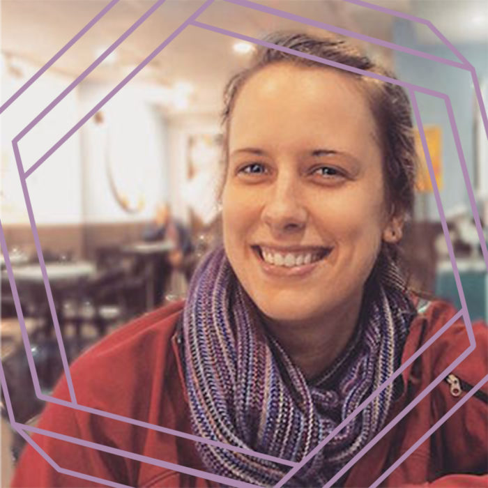 Brianne, a white woman wearing a purple scarf and red jacket, smiles at the camera. There is a stylized purple hexagon superimposed over the photo.