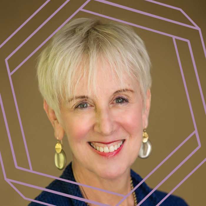 Rosalind, a white woman in her 60s with short blonde hair, smiles at the camera. There is a stylized purple octagon superimposed over the photo.