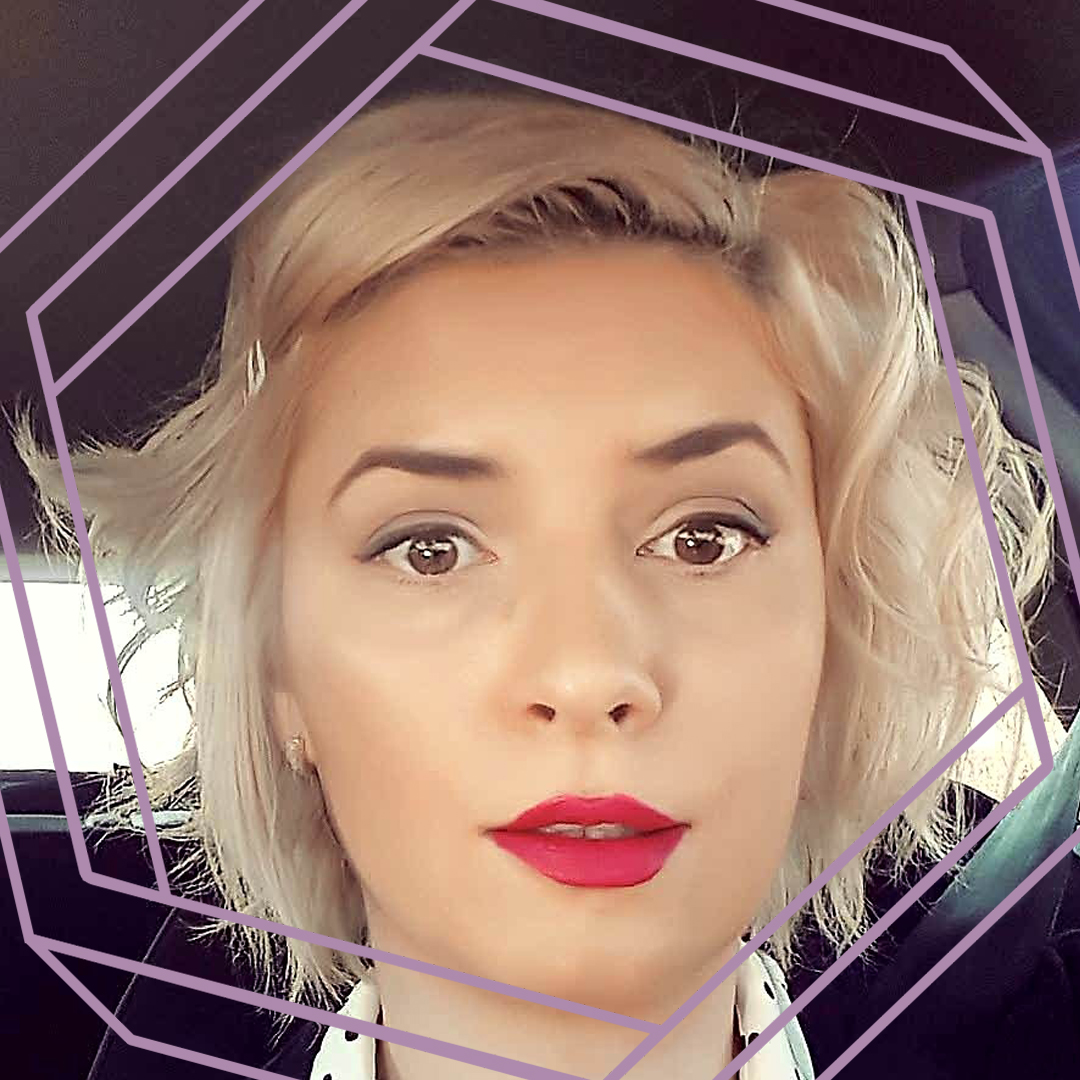 A photo of Ruxandra's face. She has curly blonde bobbed hair and wears bright red lipstick. There is a stylized purple hexagon superimposed over the image.