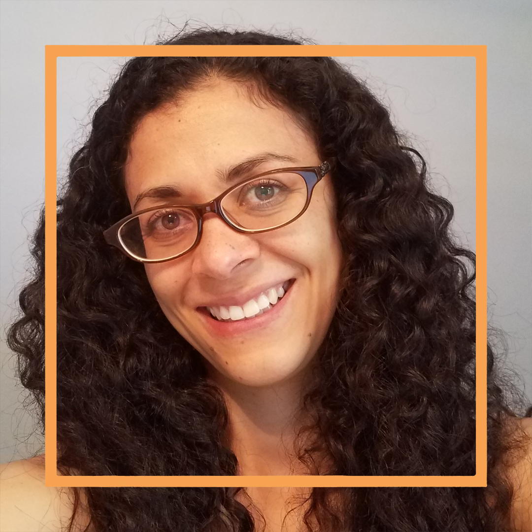 Sara, a woman with long curly brown hair and dark plastic framed glasses, smiles at the camera. There is an orange square superimposed over the photo.